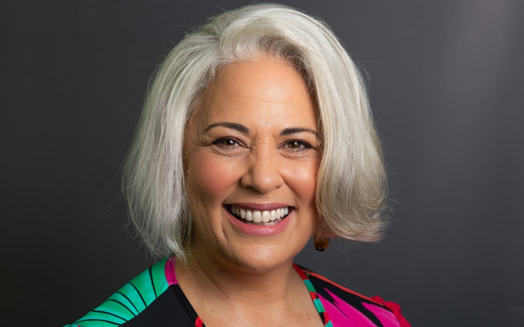 Susana Lei'ataua smiling in front of grey background