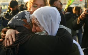 Supporters react after the jailed leader of the Kurdistan Workers' Party (PKK) Abdullah Ocalan, 75, called on the Kurdistan Workers' Party (PKK) to disarm and dissolve itself in Diyarbakir, southeastern Turkey, on February 27, 2025. Abdullah Ocalan called on February 27, 2025 for his Kurdish militant group to lay down its weapons and dissolve itself in a landmark declaration read out in Istanbul. (Photo by Ilyas AKENGIN / AFP)