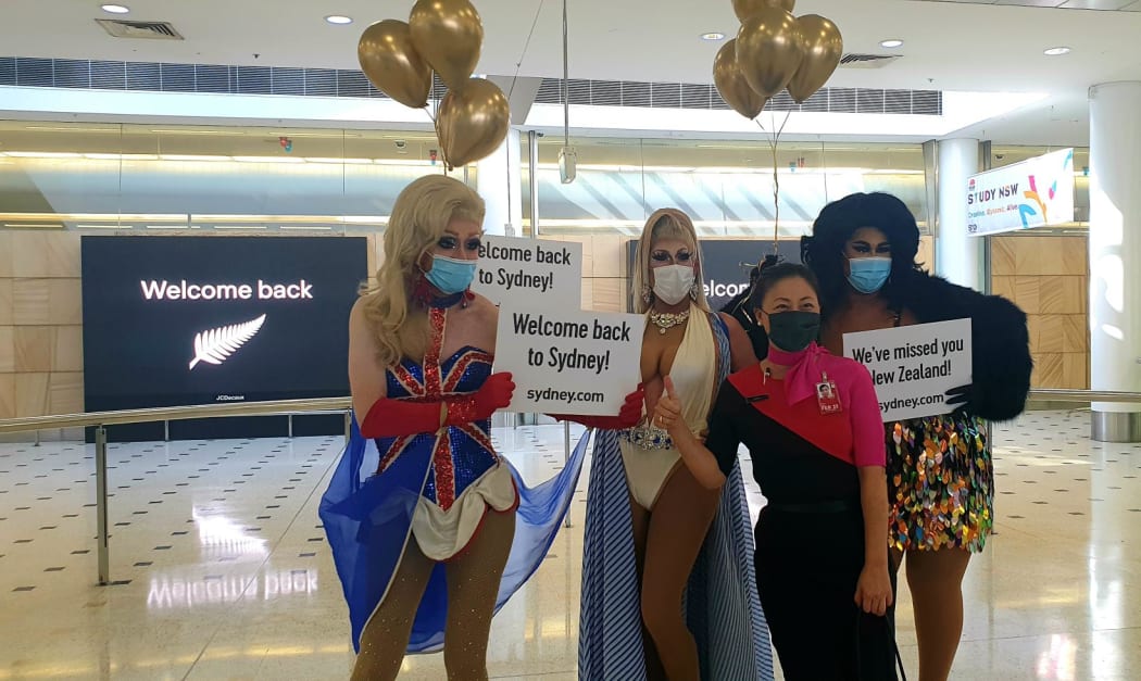 Drag queens welcome visitors to Australia on the first day of the trans-Tasman bubble