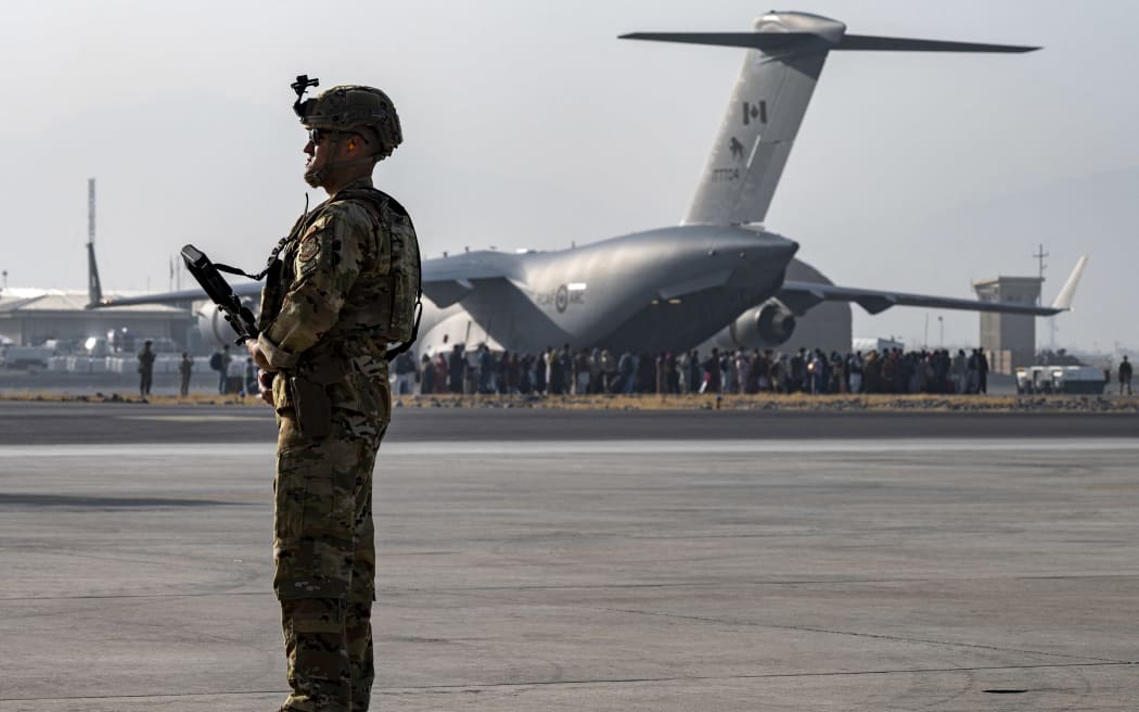 US Air Force security forces maintain a security cordon around a US Air Force C-17 Globemaster III aircraft at Hamid Karzai International Airport, Kabul, Afghanistan, on 20 August, 2021.