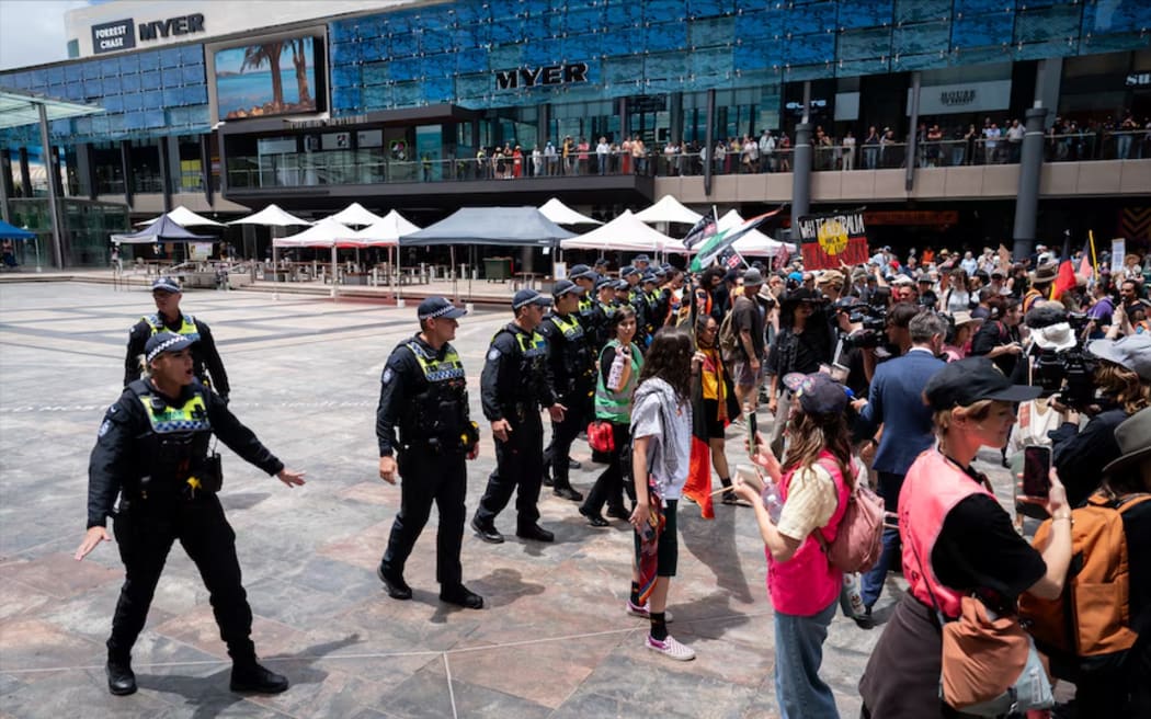 Crowds were moved away from the stage by police when the Invasion Day rally was interrupted.