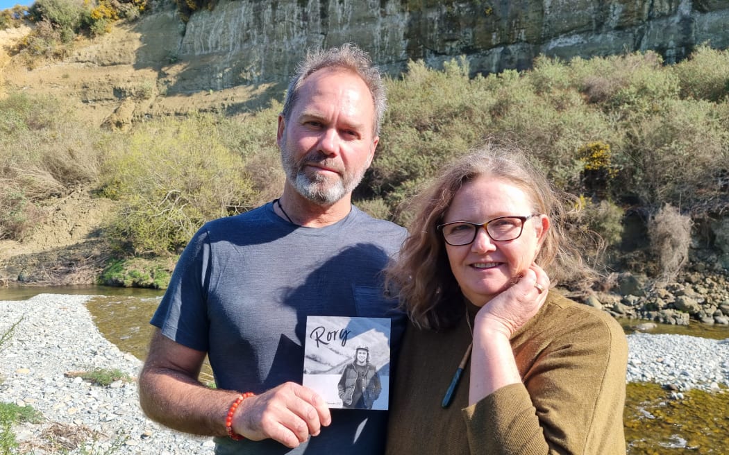 Brett and Chris Nairn hold a photo of their son Rory.