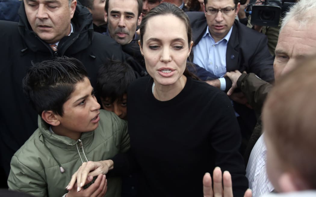 UNHCR's Goodwill Ambassador Angelina Jolie Pitt (C) visiting refugees during her visit to the port of Piraeus.