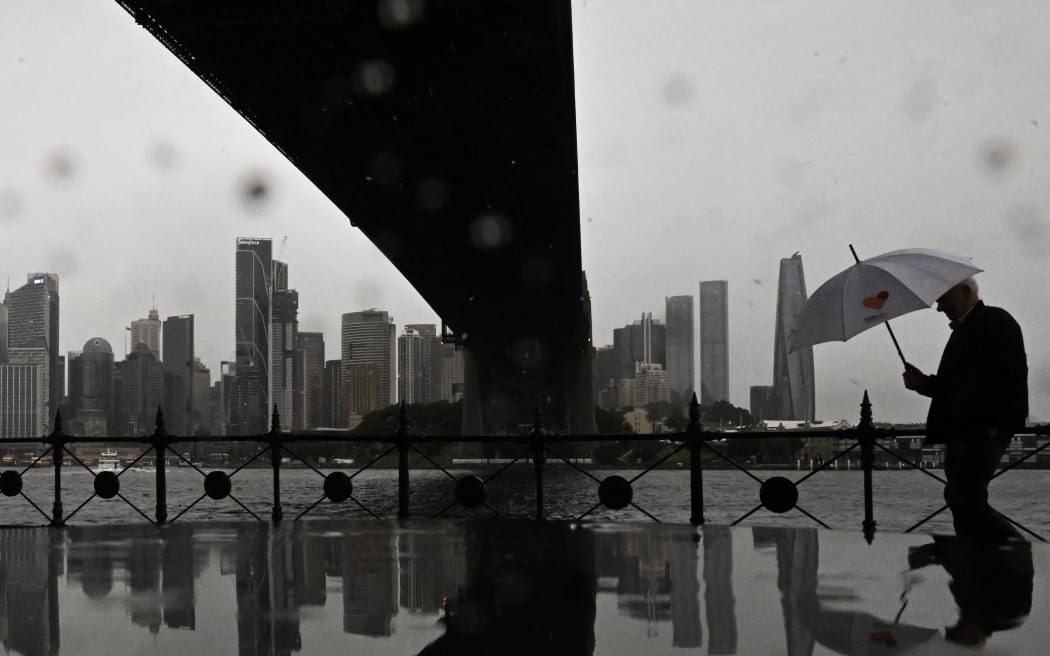 A man walks through the rain at Milsons Point in Sydney.