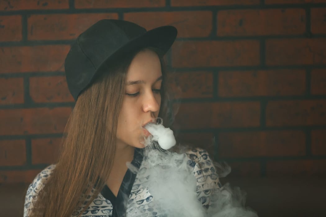 A teenager vapes.
