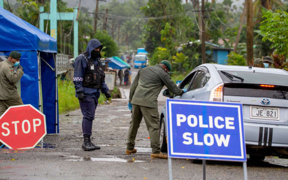 Fiji security forces inspect cars at a security check post at a residential area as they enforce face mask protocols in Fiji's capital Suva.