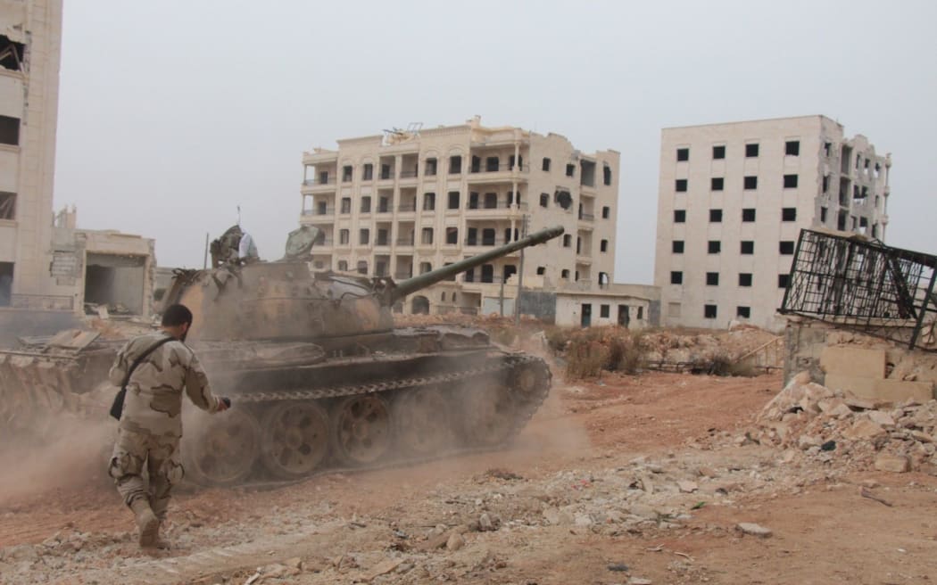 A Syrian opposition group prepare to attack Assad-regime forces with missiles during an operation to break the siege in Aleppo on Friday.