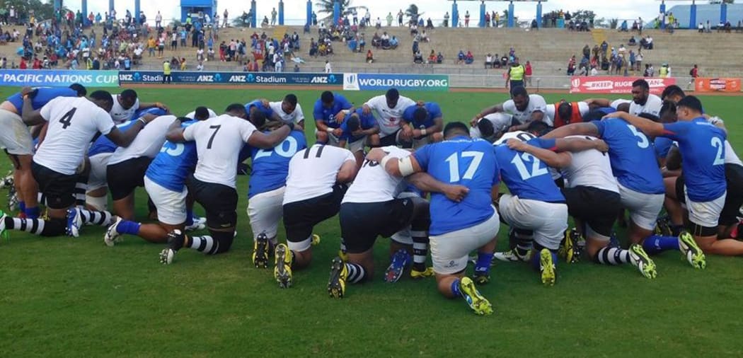 Fiji and Samoa players come together for a prayer post-match.