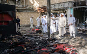 This handout photo provided by the Kuwaiti News Agency (KUNA) on June 3, 2026 shows Kuwaiti Prime Minister Sheikh Ahmad al-Abdullah al-Sabah (2R) inspecting the damaged airport after an Iranian attack, in Kuwait City. Kuwait demanded that two Iranian embassy staff leave the country within 24 hours on June 3 after an Iranian attack on the country's airport that killed one person and injured dozens more. (Photo by KUNA / AFP) / RESTRICTED TO EDITORIAL USE - MANDATORY CREDIT 
