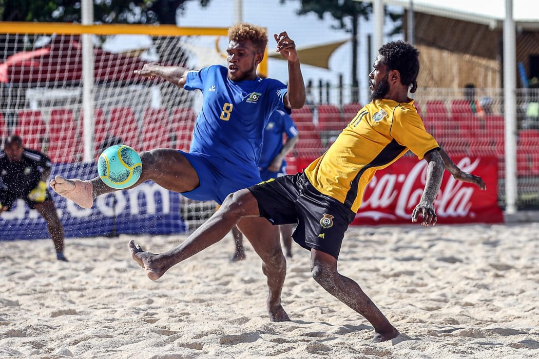 Solomon Islands Anthony Talo gets a foot to the ball ahead of Vanuatu's Loic Boulet. OFC Beach Soccer Nations Cup 2019, Aorai Tini Hau, Tahiti, Tuesday 18th June 2019.