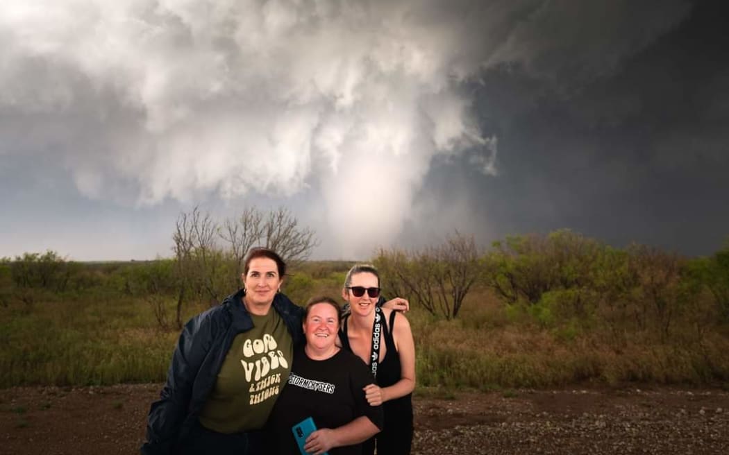 Kim Watson (middle) with friends Pam and Ally in front of a tornado in Oklahoma, 2024.