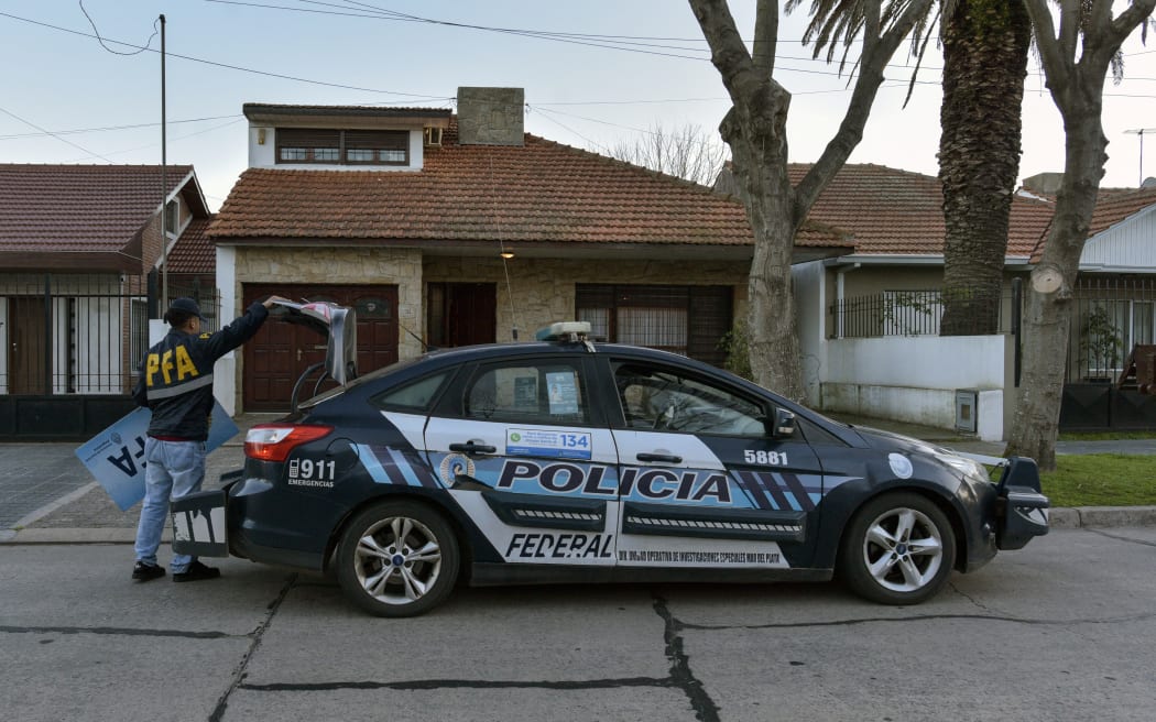 A member of the Argentine Federal Police (PFA) stands outside the house that was raided after a photo showing a 17th century masterwork allegedly stolen by the Nazis from a Dutch Jewish art collector appeared in an advertisement for the sale of the property, in Parque Luro neighbourhood, Mar del Plata, Argentina, on 27 August, 2025.