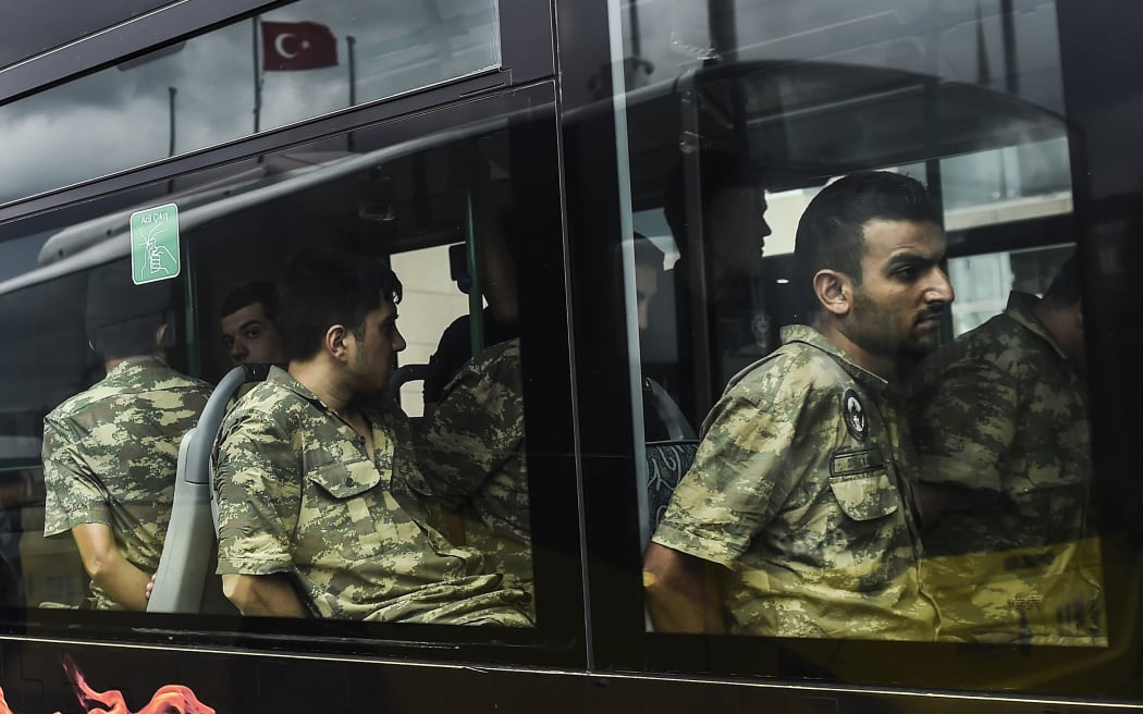 Detained Turkish soldiers who allegedly took part in a military coup arrive in a bus at the courthouse in Istanbul on 20 July.