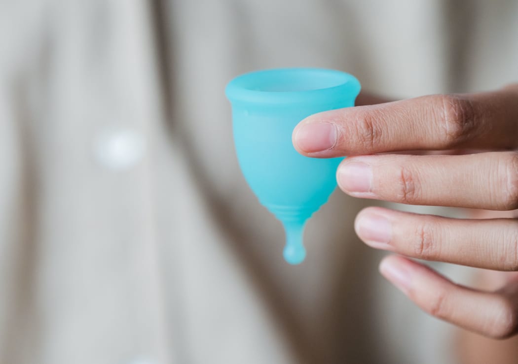 hand holding menstrual cup