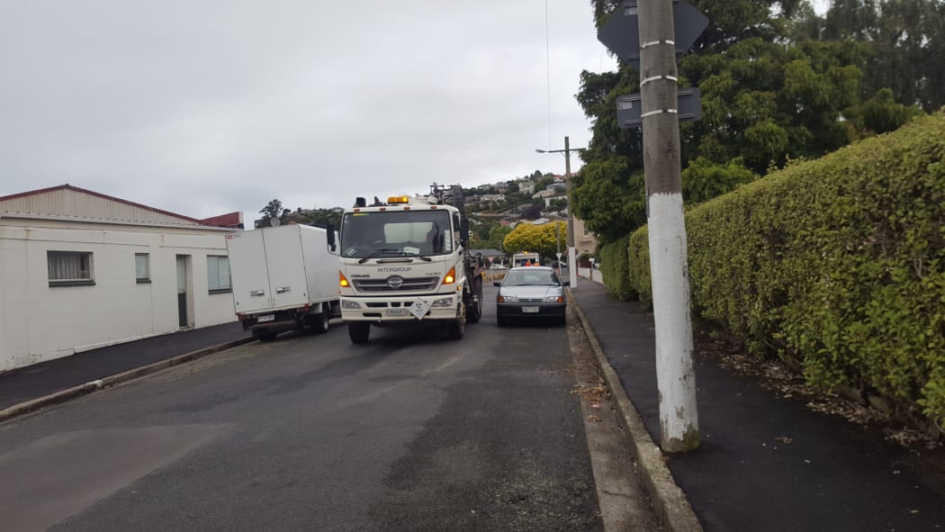Contractors working on the road to clean up the debris in Dunedin left over after storm Fehi passed through.