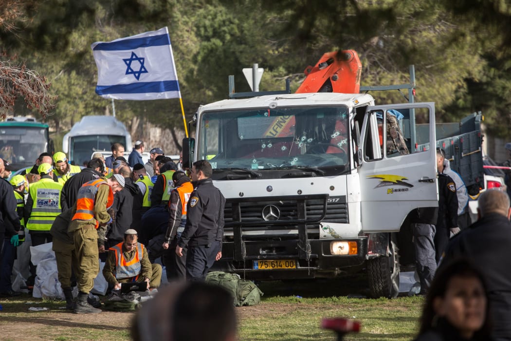 Officials examine the scene of the attack, which left four people dead.