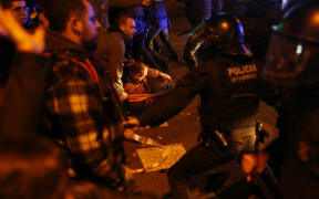 Demonstrators scuffle with riot police officers during a protest called by pro-independence Catalan movements in Barcelona.