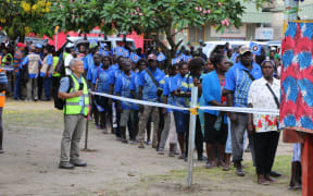 People queue at a referendum polling booth in Buka as voting gets underway in Bougainville for the autonomous PNG region's referendum on possible independence.