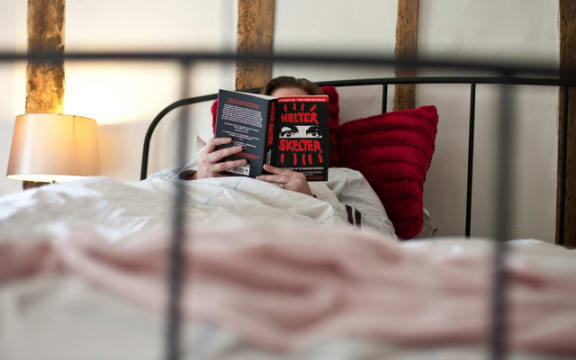 woman reading in bed