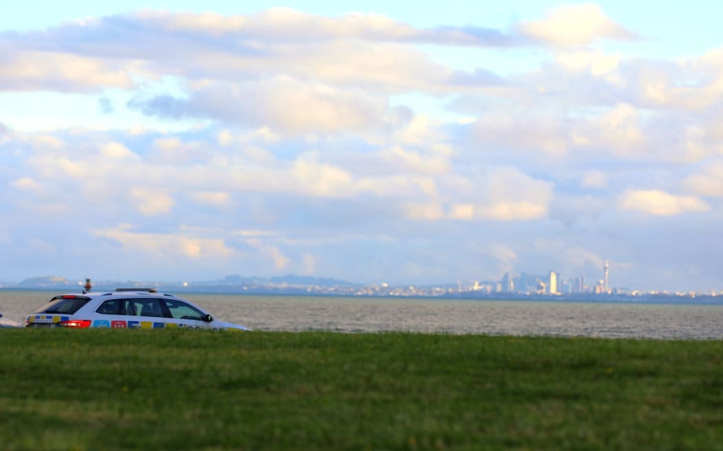 A police car at Laurie Southwick Parade near the Gulf Harbour ferry terminal where a body was found wrapped in bags in the water on 12 March, 2024.
