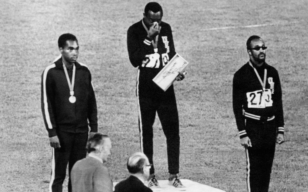 Jim Hines of the USA (C), Lennox Miller of Jamaica (L) and Charles Greene of the USA stand on the podium after receiving their medals for the men's 100m event at the 1968 Mexico Olympic Games. Hines equalled the world record of 9.9 seconds to take the gold.