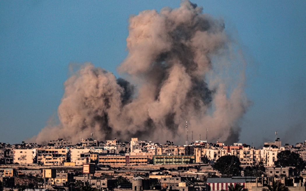 This picture taken from Rafah in the southern Gaza Strip shows smoke billowing during Israeli bombardment on Khan Yunis on February 22, 2024, amid continuing battles between Israel and the Palestinian militant group Hamas. (Photo by SAID KHATIB / AFP)