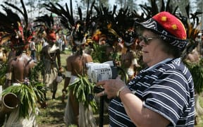 An American tourist video tapes a performance during the annual sing-sing cultural festival in PNG in 2004.