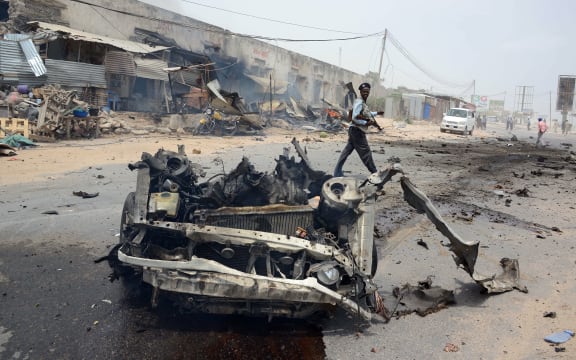 The wreckage of a car shortly after it exploded near the entrance to Mogadishu international airport.