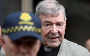 File photo taken on February 26, 2019 shows Cardinal George Pell (R) leaving the County Court of Victoria court in Melbourne