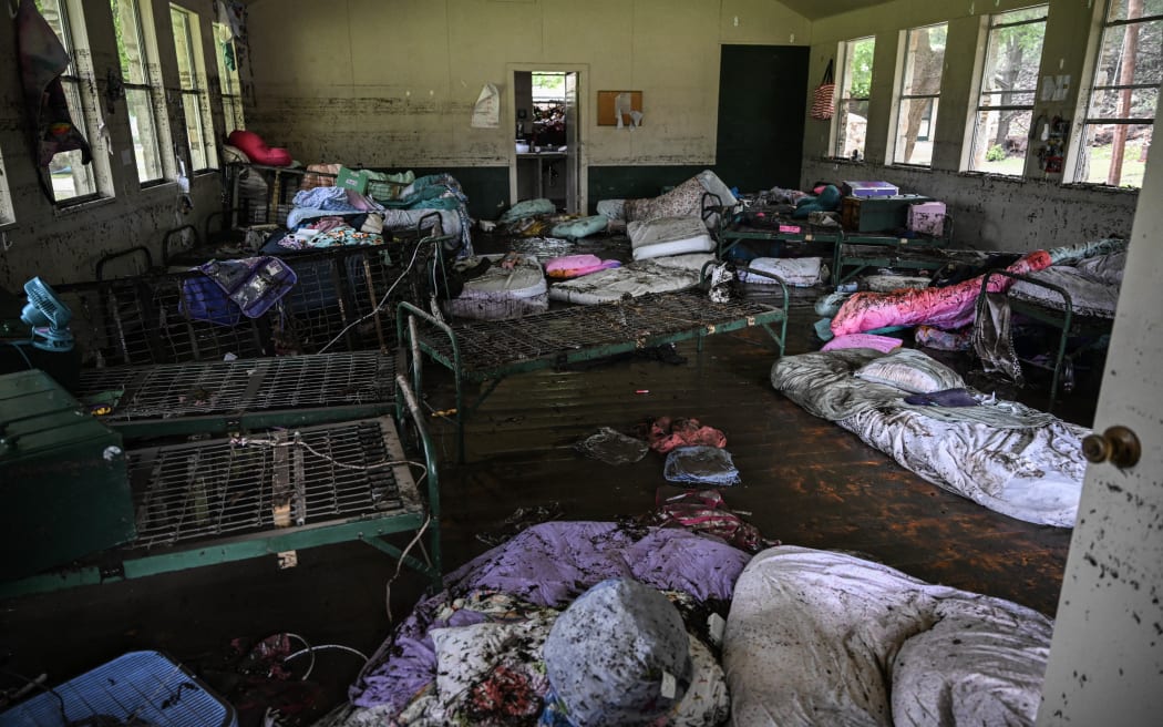 A view inside of a cabin at Camp Mystic, the site of where at least 20 girls went missing after flash flooding in Hunt, Texas, on July 5, 2025. Rescuers were on Saturday searching for more than 20 girls missing from a riverside summer camp in the US state of Texas, after torrential rains caused devastating flooding that killed at least 27 people -- with more rain on the way. "So far, we've evacuated over 850 uninjured people, eight injured people and have recovered 27 deceased fatalities at this time. Of these 27, 18 are adults, nine are children," said Kerr Country Sheriff Larry Leitha on July 5. (Photo by RONALDO SCHEMIDT / AFP)