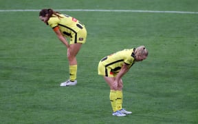 Phoenix pair Mackenzie Barry (L) with Betsy Hassett stand dejected after their women's A-League loss to Melbourne City FC.