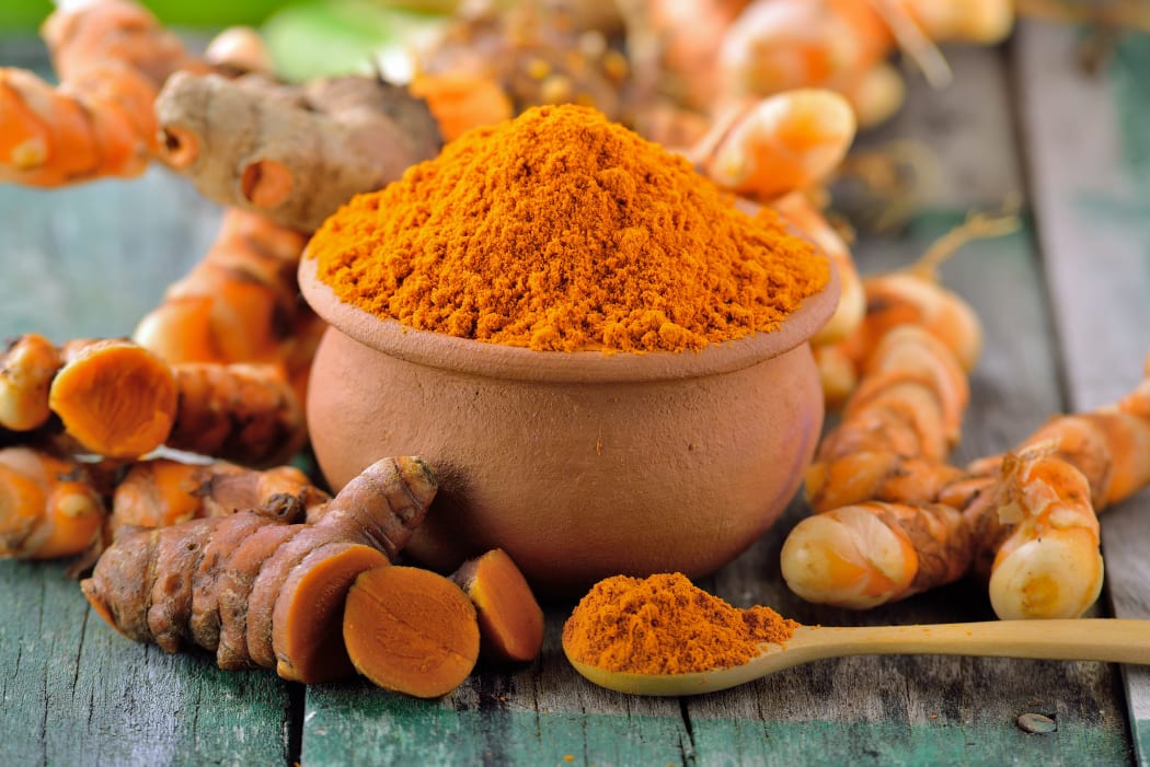 turmeric roots in the basket on wooden table