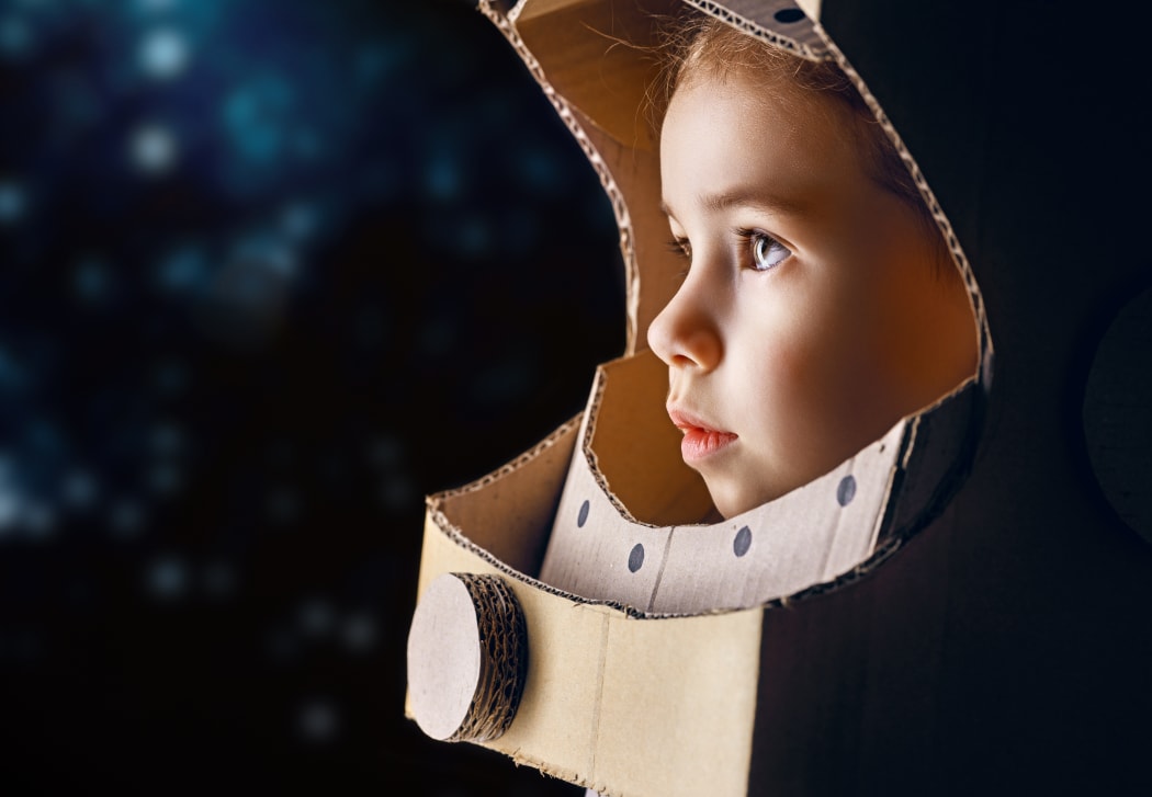 boy in cardboard astronaut costume