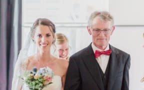 Melissa Hogenboom and her father Piet walking down the aisle on her wedding day