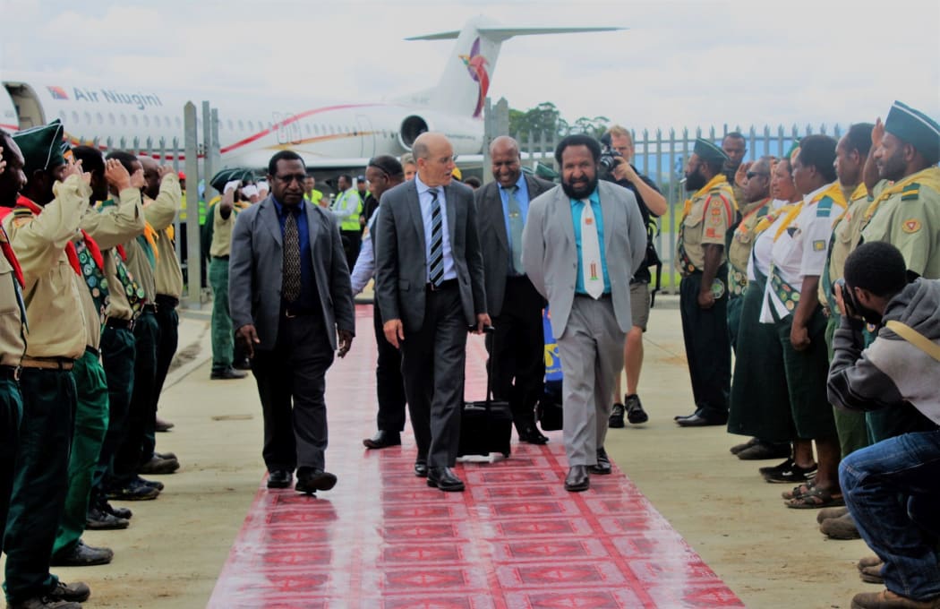 American evangelist Doug Batchelor (centre) is welcomed to Papua New Guinea's Mt Hagen by MP Don Polye (light suit, white tie), surrounded by saluting Seventh Day Adventist youths