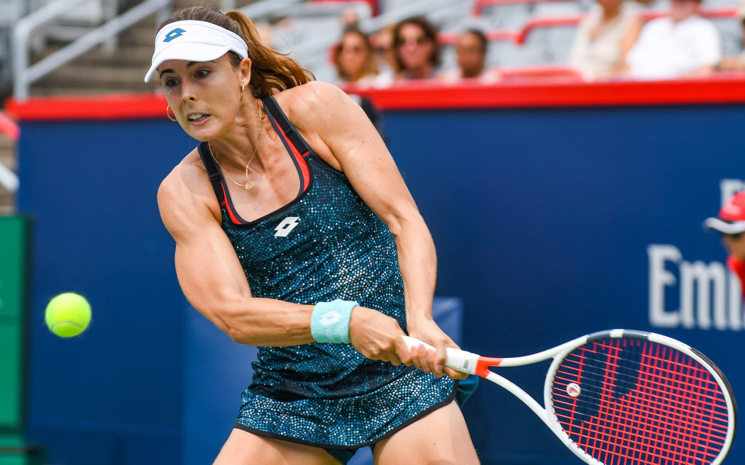 French tennis players Alize Cornet has been issued a code violation for taking off her top at the US Open.