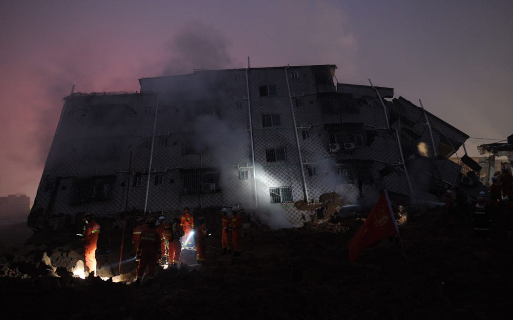 Rescuers look for survivors after a landslide hit an industrial park in Shenzhen, south China's Guangdong province on December 20, 2015