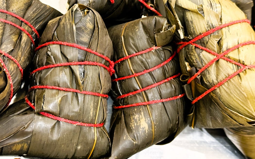 During the Dragon Boat Festival, people enjoy zongzi, and in some regions, they are filled with pork and salted egg yolk.