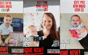 A collage of posters showing photos of Israeli hostages Shiri, Ariel and Kfir Bibas, who were held in the Gaza Strip after the 7 October, 2023 attack by Hamas militants.