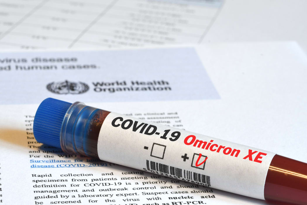 Blood tube for test detection of virus Covid-19 Omicron XE Variant with positive result on papers document.