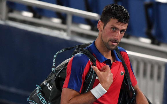 Serbia's Novak Djokovic leaves the court after being defeated by Germany's Alexander Zverev in their Tokyo 2020 Olympic Games men's singles semifinal tennis match at the Ariake Tennis Park in Tokyo on July 30, 2021.
