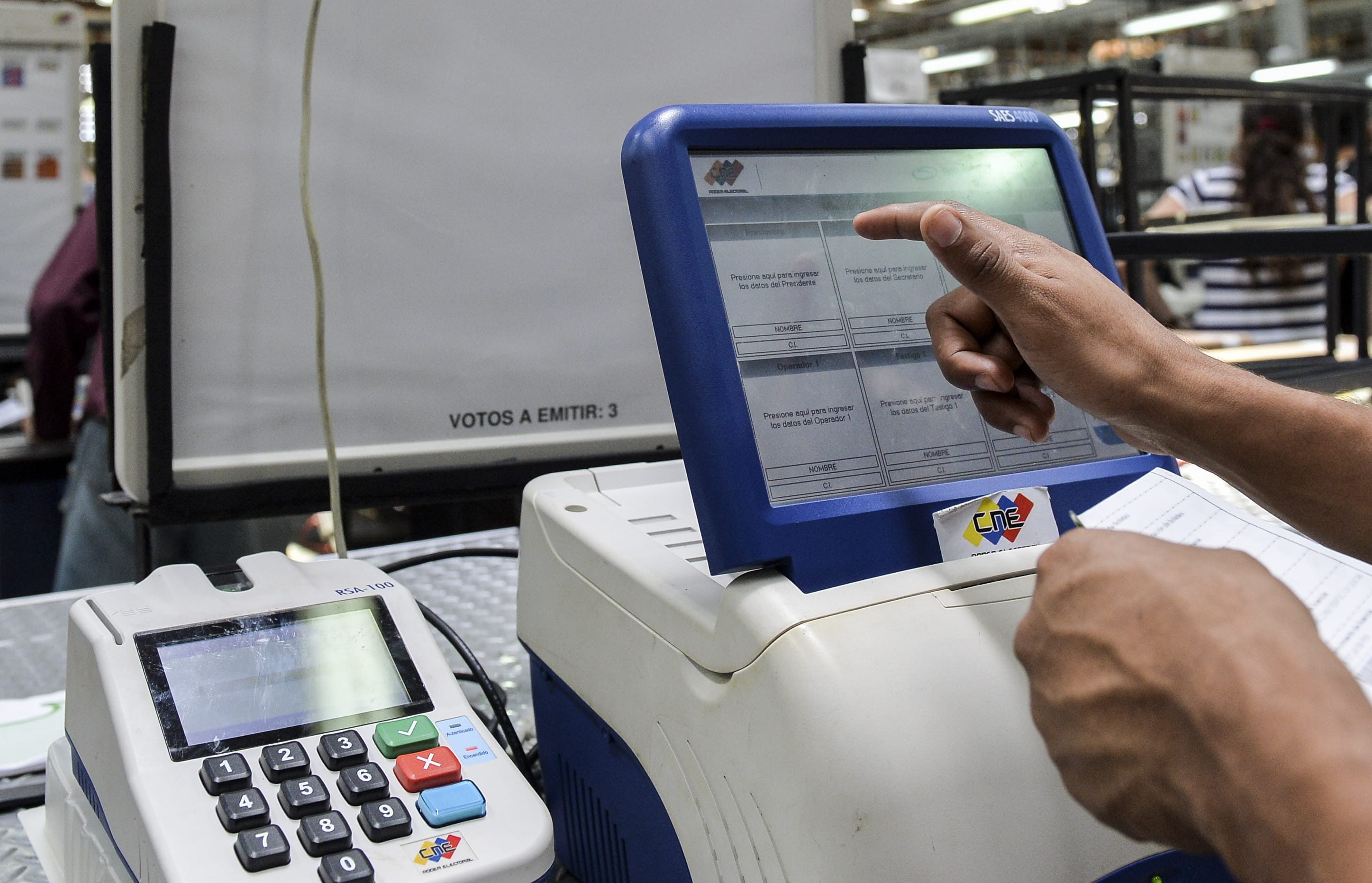 A worker tests the voting machines that will be used in the upcoming presidential elections, during an audit in Caracas on May 14, 2018.