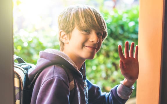 Young boy greets as he leaves home to go to school New day of ordinary life