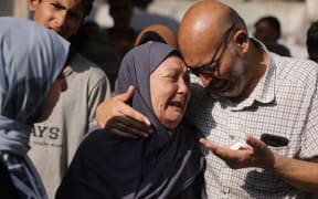 Palestinians mourn loved ones killed in Israeli strikes, at Al-Shifa hospital in Gaza City on July 23, 2025. The UN said on July 22 that Israeli forces had killed more than 1,000 Palestinians trying to get food aid since the US- and Israel-backed Gaza Humanitarian Foundation started operations in late May -- effectively sidelining the existing UN-led system.