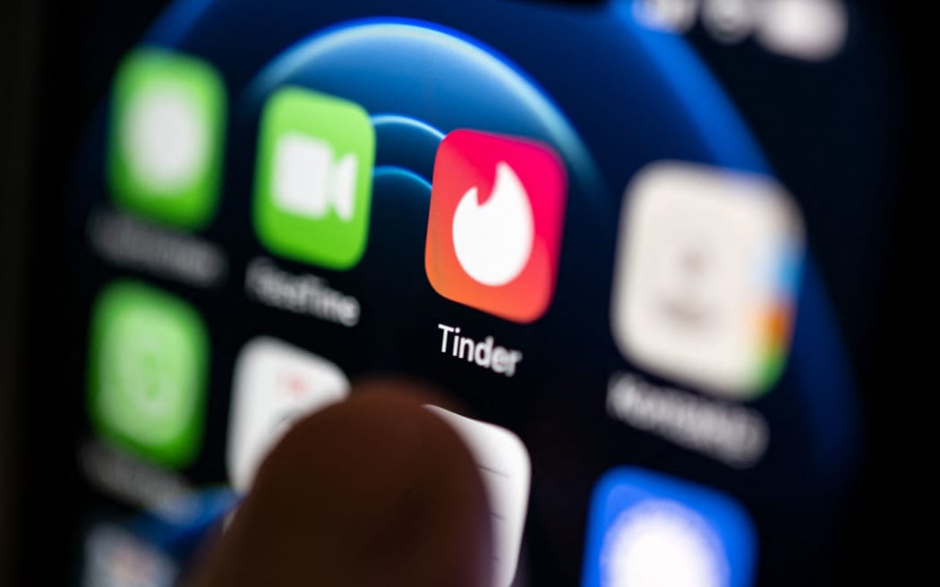PRODUCTION - 02 September 2022, Baden-Wuerttemberg, Stuttgart: ILLUSTRATION - A hand taps on the Tinder app installed on a smartphone. The dating app launched on September 12, ten years ago. (to dpa-Korr "10 years of Tinder: A decade of dating in a new dimension") Photo: Marijan Murat/dpa (Photo by MARIJAN MURAT / DPA / dpa Picture-Alliance via AFP)