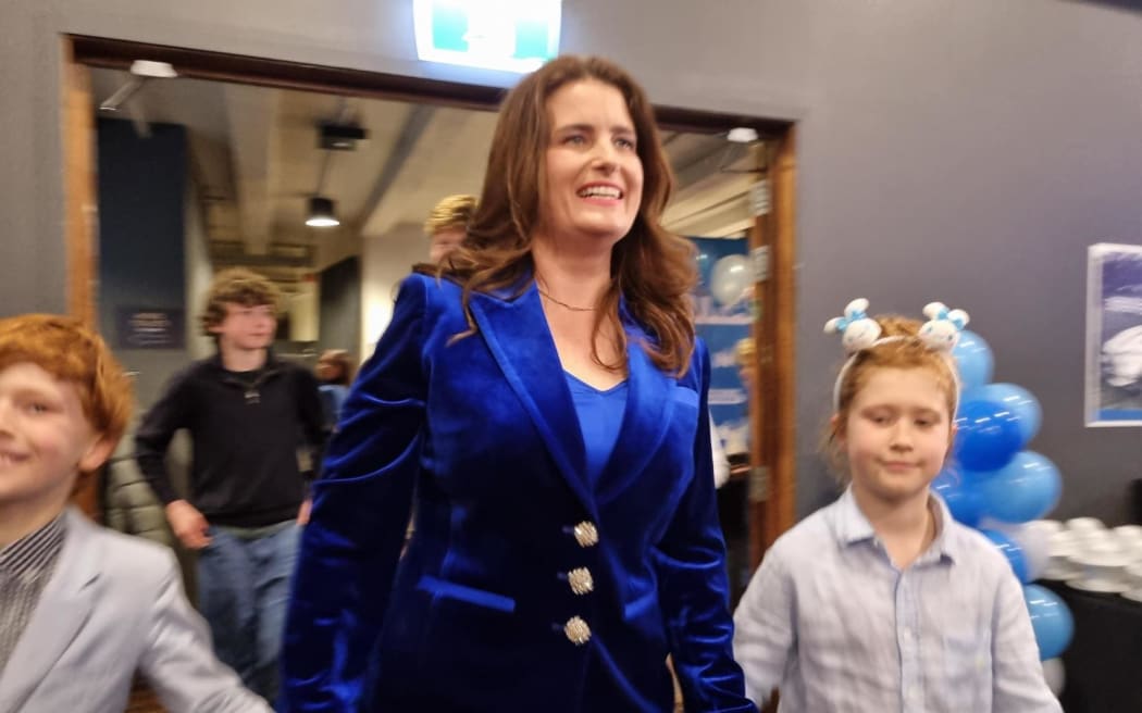 National deputy leader Nicola Willis arrives at an election night event with her children.