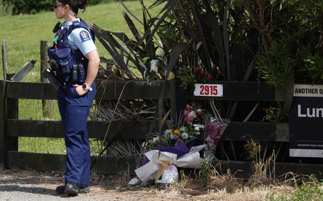 Police remain at the scene of the fatal Sanson house fire on Tuesday.