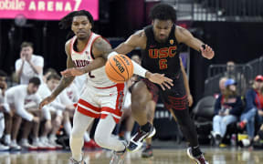 LAS VEGAS, NEVADA - MARCH 14: Caleb Love #2 of the Arizona Wildcats and Bronny James #6 of the USC Trojans battle for the ball in the first half of a quarterfinal game of the Pac-12 Conference basketball tournament at T-Mobile Arena on March 14, 2024 in Las Vegas, Nevada.   David Becker/Getty Images/AFP (Photo by David Becker / GETTY IMAGES NORTH AMERICA / Getty Images via AFP)
