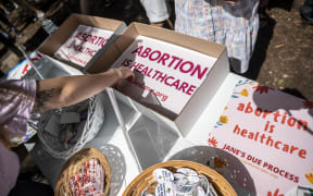 In this file photo attendees grab signs at a protest outside the Texas state capitol on May 29, 2021 in Austin, Texas.