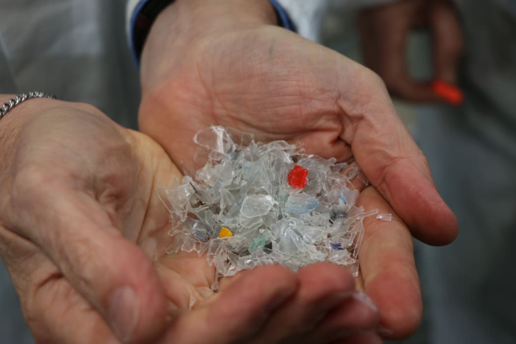 Plastic flakes, washed and broken up, ready to become semi molten before being extruded into plastic sheets for reincarnation as another plastic item at Flight Plastics.